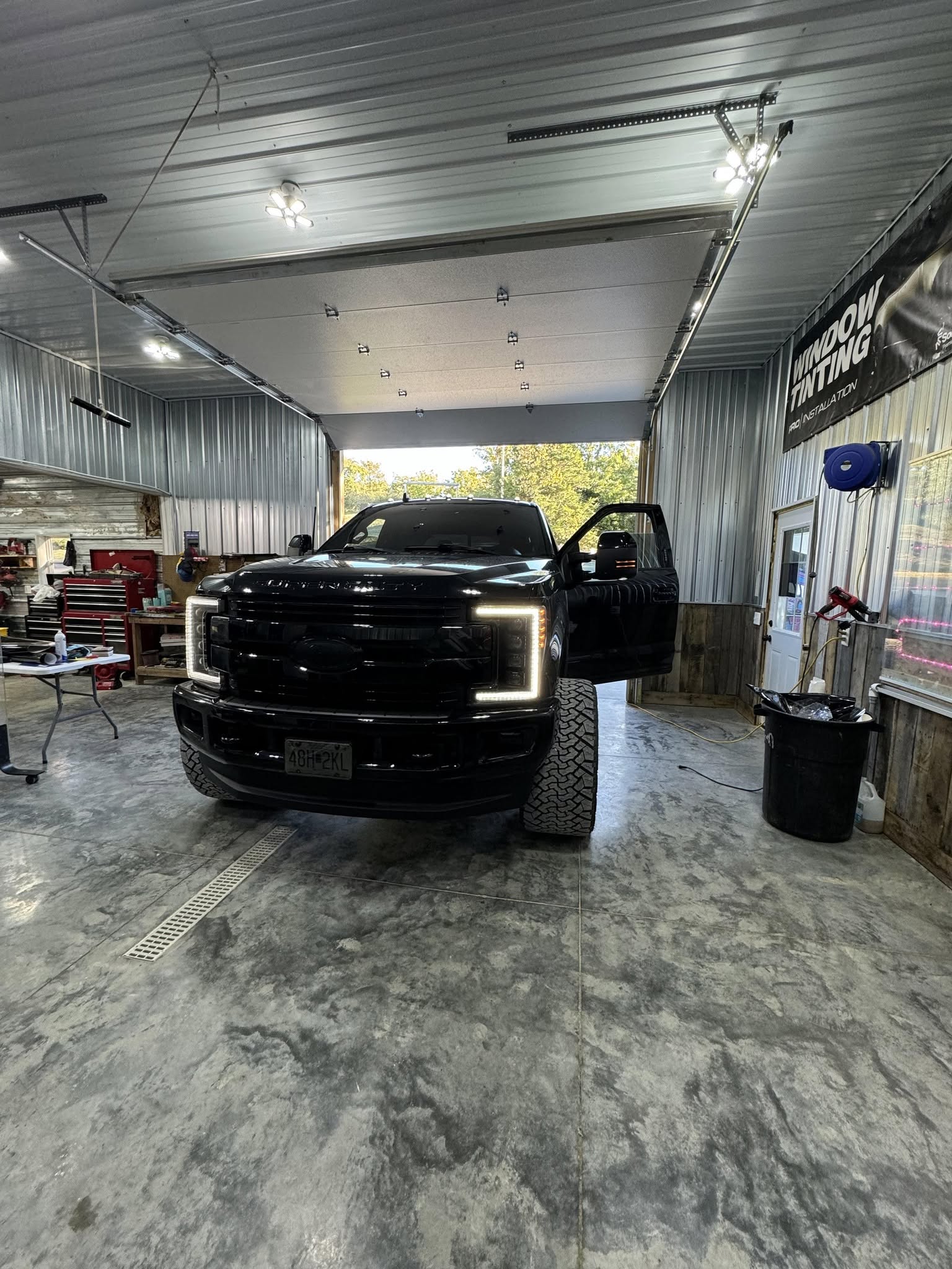 Black Chevrolet truck inside the Nic’s Graphix workshop